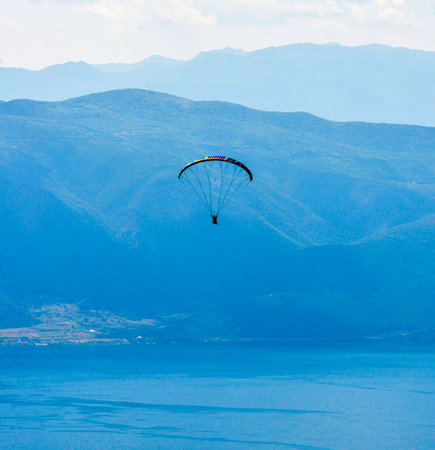Paraglider flying over the Lake Ohrid in soutwwest of macedonia.の写真素材