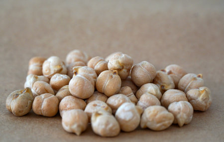 closeup of dried chickpeas legume on brown background.の写真素材