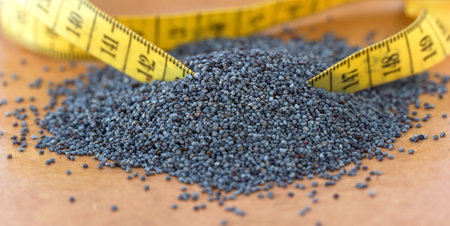Organic poppy seeds on brown background. Baking ingredientsの写真素材