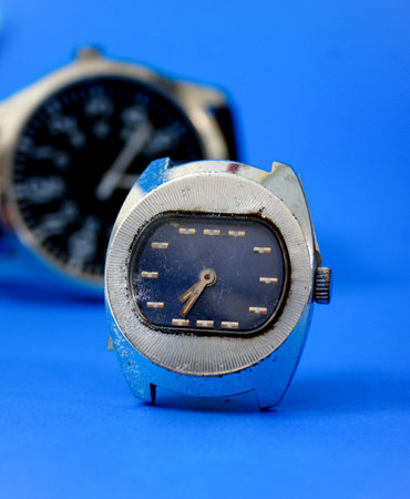 Wristwatch on a blue background. Close-up, selective focus.