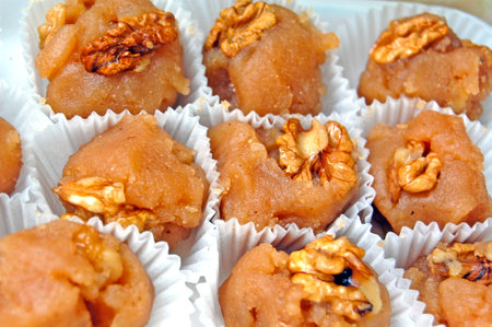 Close-up of delicious oriental sweets with walnuts in paper packaging