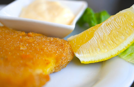 fried breaded cheese close up , served on a plate .の写真素材