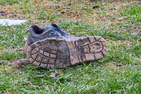 after walking old dirty winter shoes on a grass.