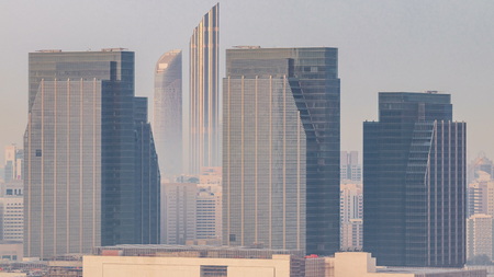 Skyscrapers on Al Reem and Al Maryah Island in Abu Dhabi timelapse from above. Aerial citiscape from Al Reem Island at morning with heavy fogの写真素材