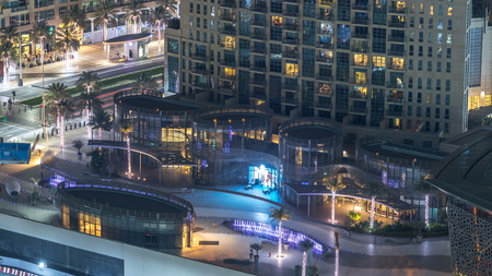Dubai downtown night timelapse, illuminated luxury modern buildings and fountains near opera, futuristic cityscape of United Arab Emirates. Aerial top view from skyscraperのeditorial素材