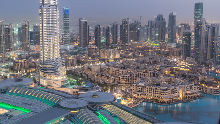 Dubai downtown day to night transition timelapse with modern illuminated skyscrapers, mall and traffic on the road. Top view from above after sunsetのeditorial素材