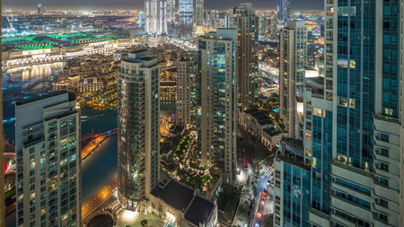 Dubai downtown night timelapse, illuminated luxury modern buildings and fountains, futuristic cityscape of United Arab Emirates. Aerial top view from skyscraperの写真素材