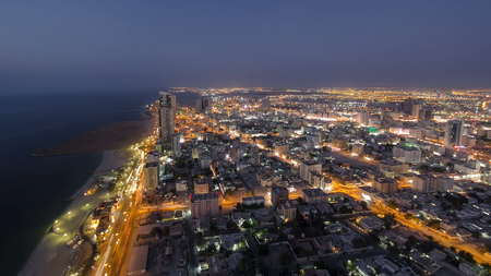 Cityscape of Ajman from rooftop from day to nigh transition timelapse. Ajman is the capital of the emirate of Ajman in the United Arab Emirates. fisheye 4Kの写真素材