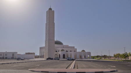 White mosque in Ajman timelapse hyperlapse with sun, United Arab Emirates