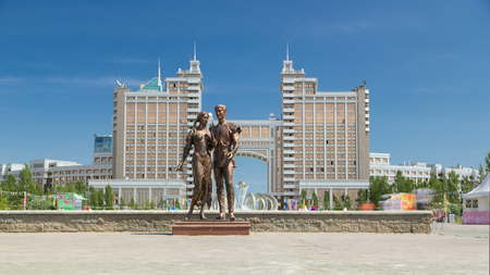 ASTANA, KAZAKHSTAN - JULY 2016: The sculpture My Happiness at the entrance to the alley of love timelapse hyperlapse. Modern buildings on background. Blue cloudy sky at summer day. Astana, Kazakhstanのeditorial素材