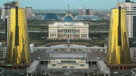 ASTANA, KAZAKHSTAN - JULY 2016: A square in front of Ak Orda with Altyn Orda business center in the foreground timelapse. Top view from bayterek. Ak Orda is the presidential residence in Astana, the capital of Kazakhstan.のeditorial素材