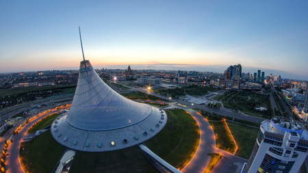 ASTANA, KAZAKHSTAN - JULY 2016: Elevated view over the city center with Khan Shatyr and central business district night to day transition Timelapse before sunrise time from rooftop, Kazakhstan, Astana, Central Asia 4Kのeditorial素材