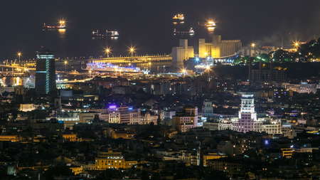 View of Barcelona night timelapse, the Mediterranean sea and port of Barcelona  from Bunkers Carmel. Catalonia, Spain. 4Kの写真素材