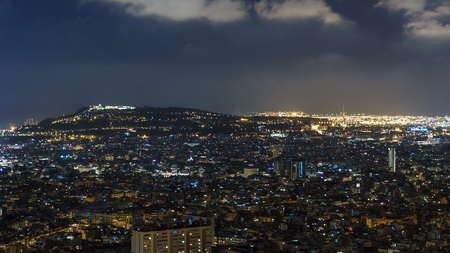 View of Barcelona night skyline timelapse, the Mediterranean sea, montjuic mountain from Bunkers...