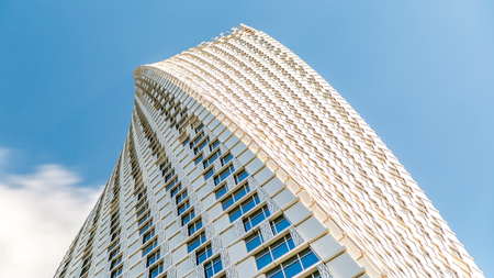 DUBAI, UAE - 03 JAN 2016: Cayan Tower timelapse (known also as Infinity Tower) in Dubai Marina. Perspective view from bottom to cloudy blue sky, The tower is world's tallest high rise building with a twist of 90 degrees - 306 metresのeditorial素材