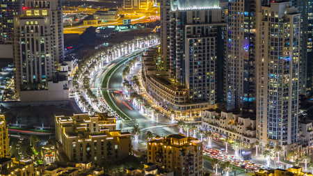 Top view of road in Dubai downtown timelapse with night traffic, metroline and illuminated skyscrapers. This is one of the iconic views of Dubai, UAEの写真素材