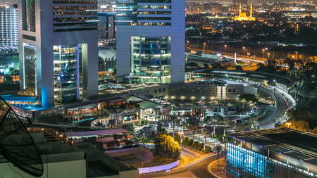 Dubai skyline from top with Emirates Towers timelapse at night time. Dubai, UAE. Jumeirah Emirates Towers, Dubai's finest city hotel, is located in commercial business district.の写真素材