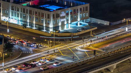 Beautiful aerial top view of road intersection at night timelapse in Dubai Marina in Dubai, UAE....