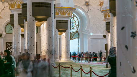 DUBAI, UAE - CIRCA JANUARY 2017: Magnificent interior of Sheikh Zayed Grand Mosque timelapse with crowd in Abu Dhabi. It is the largest mosque in UAE and the eighth largest mosque in the world.のeditorial素材