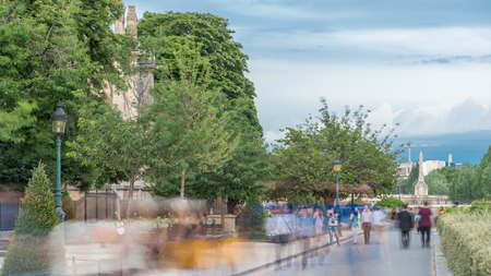 Notre Dame de Paris Garden on Cite Island timelapse, Paris, France. People walking at park with...