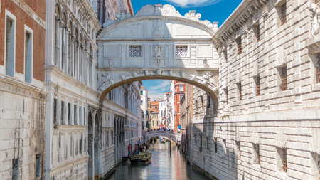 Gondolas floating on canal towards Bridge of Sighs timelapse (Ponte dei Sospiri). View from bridge Ponte della Paglia. Venice, Italyの写真素材