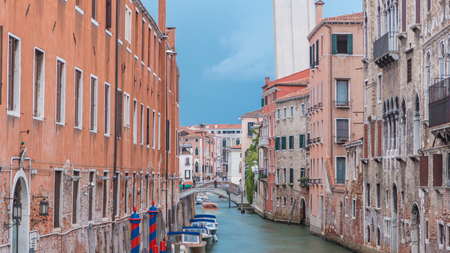 Canal in Venice timelapse. Channel, bridges, historical, old houses and boats. Scenic cityscape view. Venice, Italy. Blue sky at summer dayの写真素材