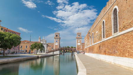 Entrance to the Arsenale timelapse hyperlapse, Venice, Veneto, Itlay and the Campo de l'Arsenale with the canal and Ponte de l'Arsenal o del Paradiso on a sunny day with few touristsの写真素材
