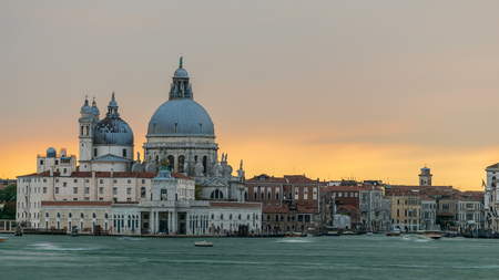 Basilica Santa Maria della Salute at sunset timelapse, Venezia, Venice, Italy. Orange cloudy sky. Boats on Grand Canalの写真素材
