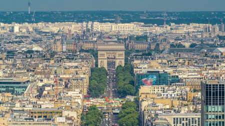 Aerial view of Paris and The Arc de Triomphe with Champs Elysees timelapse from the top of the skyscrapers in Paris business district La Defense. Sunny summer day with blue cloudy sky. Paris, Franceの写真素材