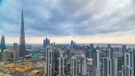 Beautiful panoramic skyline of Dubai timelapse, United Arab Emirates. View of world famous skyscrapers. Aerial top view from tower rooftop. Beautiful cloudy sky. Colourful travel and business background.の写真素材