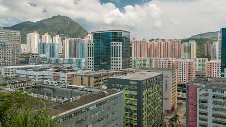 Top view of buildings at day with hills behind towers in finance urban timelapse, hong kong city...