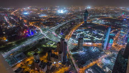 Skyline with Skyscrapers night timelapse in Kuwait City downtown illuminated at dusk. Kuwait City, Middle East. View from rooftop with foggy weatherの写真素材