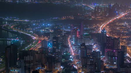 Skyline with Skyscrapers night timelapse in Kuwait City downtown illuminated at dusk. Kuwait City,...