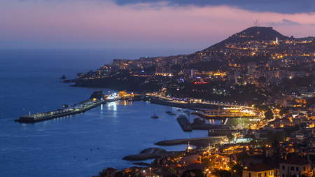 After sunset panoramic view to Funchal with atlantic ocean day to night transition, Madeira, Portugal timelapse 4Kの写真素材