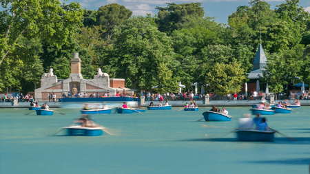 Tourists on boats at lake near Monument to Alfonso XII timelapse in the Parque del Buen Retiro -...