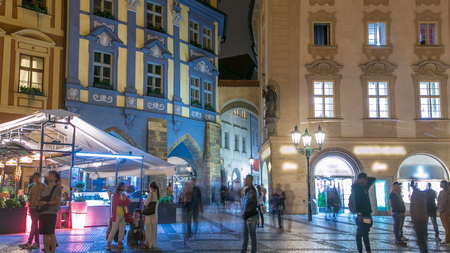 Night view of Old Town Square timelapse in Prague. Czech Republic. People walk near restaurants