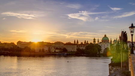 View from Charles Bridge in Prague during the sunrise timelapse, Bohemia, Czech Republic. Cloudy sky, reflection in Ltava riverの写真素材