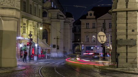 Night view of the illuminated malostranske namesti square timelapse hyperlapse in prague   which is famous for church of saint nicolas. People on tram stop. PRAGUE, CZECH REPUBLICの写真素材