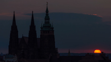 A beautiful view of Prague at sunrise on a misty morning timelapse. Prague Castle and St. Vitus Cathedral on the left and a golden rising sun in the background. Close up viewの写真素材
