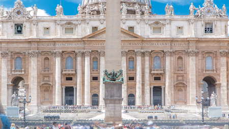 St.Peter's Square full of tourists with St.Peter's Basilica and the Egyptian obelisk within the Vatican City timelapse with tourists at summer dayのeditorial素材