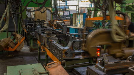 Conveyor assembly stage the body of tractor at factory timelapse. Frames assembly with red-hot...