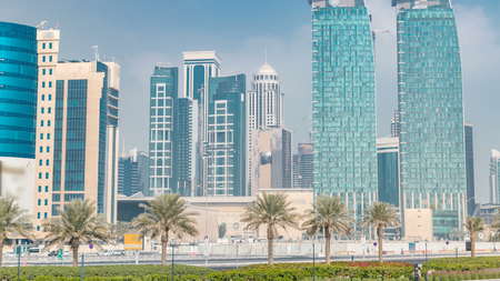 The skyline of Doha seen from Park timelapse, Qatar. Trees and palms on foreground. Mordern...