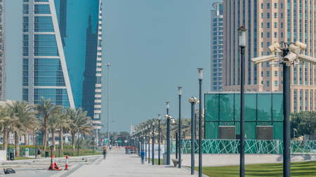 The high-rise district of Doha timelapse with walkway, seen from the Hotel Park, with skyscrapers...