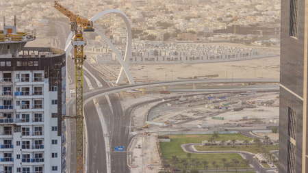 Skyscrapers and road with bridge before sunset timelapse of Doha, the capital Qatar. Aerial top view...