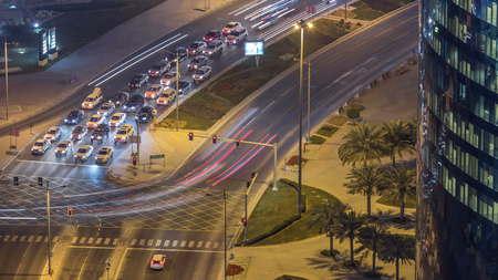 Traffic on the road of West Bay area from top in Doha timelapse, Qatar. Illuminated modern...