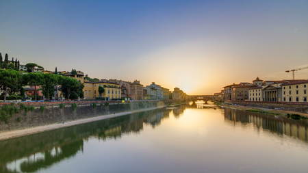 Sunset view of Florence Ponte Vecchio over Arno River in Florence timelapse, Italy. Florence architecture. One of the main landmarks in Florence.の写真素材
