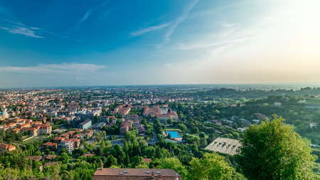 View of medieval Upper Bergamo timelapse - beautiful medieval town in north Italy. Panoramic top view. Blue cloudy sky at summer dayの写真素材