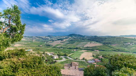 view of green summer valley of italian coyntryside timelapse with hills on background. Green trees, blue cloudy skyの写真素材