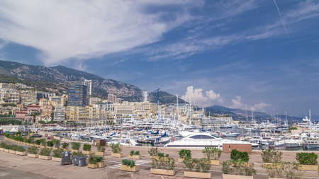 Monte Carlo Port Hercule panorama timelapse hyperlapse. View from embankment with luxury yachts, boats and houses around harbor of Monaco, Cote d'Azur.の写真素材