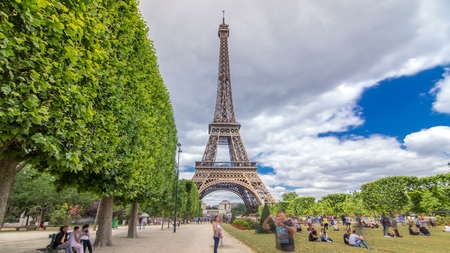 Champ de Mars and the Eiffel Tower timelapse hyperlapse in a sunny summer day. Paris, France. Green...